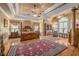 Elegant main bedroom features a four-poster bed, hardwood floors, and abundant natural light at 454 Langley Oaks Dr, Marietta, GA 30067