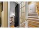 Staircase featuring hardwood steps and a decorative glass door leading to a lower level at 454 Langley Oaks Dr, Marietta, GA 30067