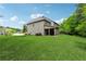 Spacious backyard with a well-maintained lawn and mature trees. The home has a covered patio at 4702 Jellico Dr, Powder Springs, GA 30127