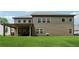 A large backyard featuring a well-maintained lawn with a covered patio at 4702 Jellico Dr, Powder Springs, GA 30127