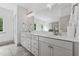 Elegant bathroom featuring double vanity and expansive mirror, offering great light at 4702 Jellico Dr, Powder Springs, GA 30127