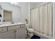 Bathroom featuring a toilet, tub, shower, and a sink with a white marble countertop at 4702 Jellico Dr, Powder Springs, GA 30127