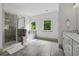 Modern bathroom featuring a glass shower, soaking tub, and double vanity at 4702 Jellico Dr, Powder Springs, GA 30127