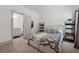 A bedroom with neutral carpet, a view of the bathroom and black shelving units at 4702 Jellico Dr, Powder Springs, GA 30127