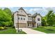 A stately stone home with a two-car garage and professionally landscaped yard offers exceptional curb appeal at 4702 Jellico Dr, Powder Springs, GA 30127