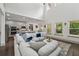 Bright open-concept living space with access to a modern kitchen and large windows offering natural light at 4702 Jellico Dr, Powder Springs, GA 30127