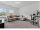 Comfortable living room featuring a sectional sofa, desk, and large windows at 4702 Jellico Dr, Powder Springs, GA 30127