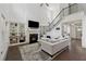 Bright living room with soaring ceilings, fireplace, built-in bookshelves, and staircase to second story at 4702 Jellico Dr, Powder Springs, GA 30127