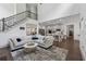 Open concept living space leading to a modern kitchen, with high ceilings and staircase with iron railing at 4702 Jellico Dr, Powder Springs, GA 30127
