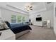 Bright and open primary bedroom with a tray ceiling, large windows, and modern decor at 4702 Jellico Dr, Powder Springs, GA 30127