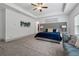 Bright primary bedroom with tray ceiling, a blue accent wall and luxury seating area at 4702 Jellico Dr, Powder Springs, GA 30127