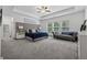 Spacious primary bedroom featuring a tray ceiling, a sitting area, and large windows at 4702 Jellico Dr, Powder Springs, GA 30127
