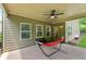 Relaxing covered patio featuring a ceiling fan and a cozy hammock for outdoor enjoyment at 4702 Jellico Dr, Powder Springs, GA 30127