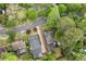 Aerial view of homes with lush trees, landscaped yards, and a multi-level deck in the backyard at 557 E Wesley Ne Rd, Atlanta, GA 30305