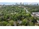 Aerial view of a neighborhood, lush green trees and the skyline of Atlanta in the distance at 557 E Wesley Ne Rd, Atlanta, GA 30305