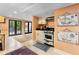 Finished basement with travertine flooring, french doors, and kitchenette with white cabinetry at 557 E Wesley Ne Rd, Atlanta, GA 30305