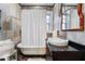 Bathroom featuring a clawfoot tub, vessel sink, and stylish decor at 557 E Wesley Ne Rd, Atlanta, GA 30305
