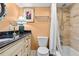 Well-lit bathroom featuring a granite vanity top, complemented by tile work at 557 E Wesley Ne Rd, Atlanta, GA 30305