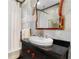 Bathroom featuring a clawfoot tub, vessel sink, and stylish decor at 557 E Wesley Ne Rd, Atlanta, GA 30305