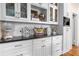 Butler's pantry with marble counter, glass display cabinets, and built-in appliances at 557 E Wesley Ne Rd, Atlanta, GA 30305