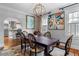 Dining room features decorative floral chairs, hardwood floors and an arched doorway at 557 E Wesley Ne Rd, Atlanta, GA 30305
