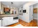 Bright kitchen featuring white cabinets, built-in oven, and hardwood floors at 557 E Wesley Ne Rd, Atlanta, GA 30305