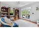 Stylish living room with hardwood floors, bookshelves, and access to outdoor patio at 557 E Wesley Ne Rd, Atlanta, GA 30305