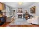 Bright living room with fireplace, hardwood floors, large windows, and stylish decor at 557 E Wesley Ne Rd, Atlanta, GA 30305