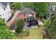 Aerial view of a brick home with a multi-level deck and a landscaped yard at 557 E Wesley Ne Rd, Atlanta, GA 30305