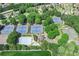 Overhead view of community tennis courts and pool, surrounded by mature trees and landscaping at 6725 Polo Dr, Cumming, GA 30040