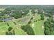 Panoramic aerial view of the golf course featuring lush fairways, water features, and wooded areas at 6725 Polo Dr, Cumming, GA 30040