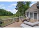 Back deck showcasing a golf course view, complete with outdoor seating and lounge chairs for relaxation at 6725 Polo Dr, Cumming, GA 30040