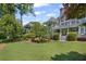 Expansive backyard featuring a spacious lawn and an elegant home with multiple levels and outdoor living spaces at 6725 Polo Dr, Cumming, GA 30040