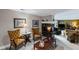 Cozy basement nook with a fireplace, decorative lamps, framed prints, and comfortable seating at 6725 Polo Dr, Cumming, GA 30040
