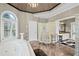 Bright bathroom with soaking tub, shower, arched windows, double vanity and marble tile floors at 6725 Polo Dr, Cumming, GA 30040