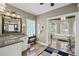 Spacious bathroom featuring granite countertops, vanity and soaking tub with arched windows at 6725 Polo Dr, Cumming, GA 30040