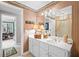 Bathroom features a large mirror, a vanity with a white countertop, and decorative wallpaper at 6725 Polo Dr, Cumming, GA 30040