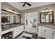 Elegant bathroom featuring granite countertops, dual sinks, and a view into the bedroom at 6725 Polo Dr, Cumming, GA 30040