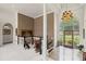 Elegant foyer with staircase, decorative front door, marble flooring, and chandelier lighting at 6725 Polo Dr, Cumming, GA 30040
