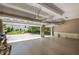 Spacious three-car garage with high ceilings and automatic doors leading to a manicured yard at 6725 Polo Dr, Cumming, GA 30040