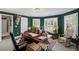 Inviting home office featuring custom built-ins, plantation shutters and a striking deer head mount at 6725 Polo Dr, Cumming, GA 30040
