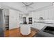 Bright kitchen featuring white cabinets, a central island, and hardwood floors at 6725 Polo Dr, Cumming, GA 30040