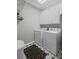 Neat laundry room with white washer, dryer, white cabinets, and patterned tile flooring at 6725 Polo Dr, Cumming, GA 30040