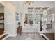 Elegant living room with coffered ceilings, columns, archways, large windows, and staircase at 6725 Polo Dr, Cumming, GA 30040