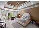 Large bedroom with natural light, tray ceiling, and neutral color palette at 6725 Polo Dr, Cumming, GA 30040