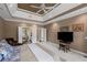 Spacious primary bedroom featuring a tray ceiling and ensuite bathroom entrance at 6725 Polo Dr, Cumming, GA 30040