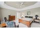 Spacious bedroom featuring tray ceiling, warm colors, and a sitting area at 6725 Polo Dr, Cumming, GA 30040
