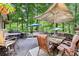Inviting back deck surrounded by lush trees and multiple outdoor seating areas at 989 Pinfeather Ct, Lawrenceville, GA 30043