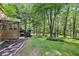 Exterior view shows a lush backyard and deck at 989 Pinfeather Ct, Lawrenceville, GA 30043