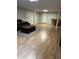 Spacious finished basement featuring a wood-look floor, an elegant coffered ceiling, and a recreational seating area at 989 Pinfeather Ct, Lawrenceville, GA 30043